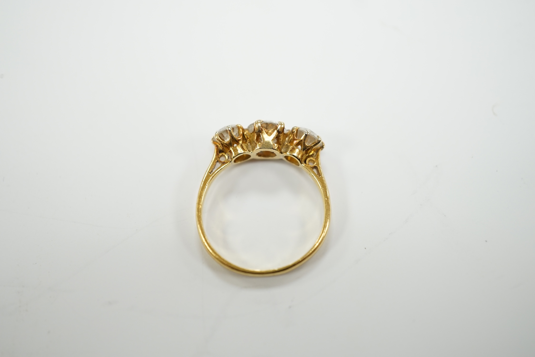 A George V 18ct gold and three stone diamond set ring, the central stone weighing approx. 0.60ct, size L, gross weight 2.5 grams.